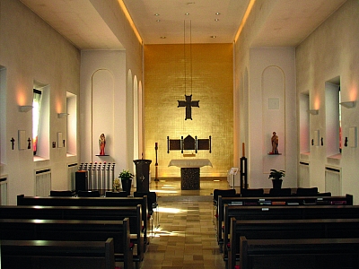 Kapelle im St. Elisabeth Hospital – Innenraum mit Altar Innenraum der Kapelle im St. Elisabeth Hospital mit Blick auf den Altar, das goldene Rückwandkreuz und die Kirchenbänke